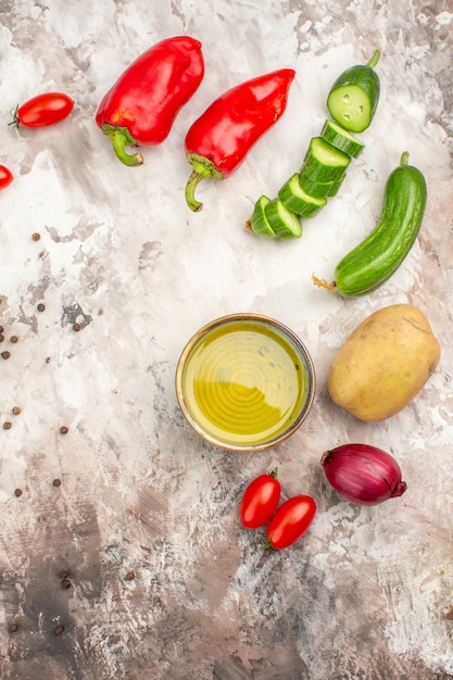 Top view of whole and chopped fresh vegetables and oil