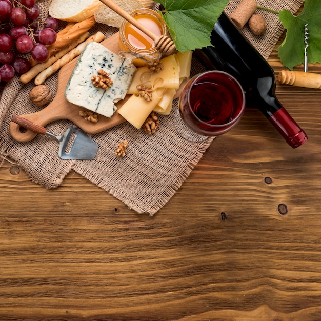 Top view wine with food and bunch of grapes