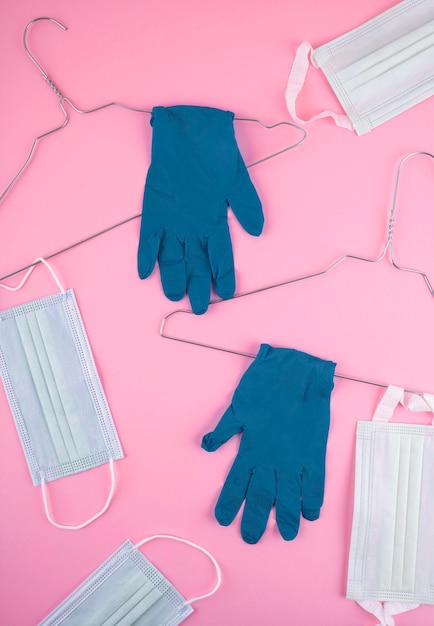 Top view of wire hangers with surgical gloves and medical masks