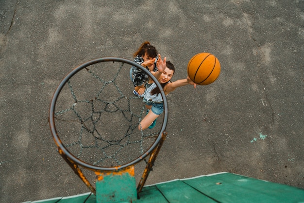 Free photo top view with hoop of girls playing basketball