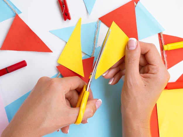 Free photo top view of woman cutting colorful paper