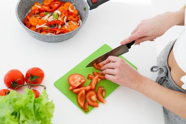 Top view woman cutting tomatoes