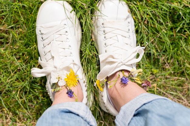 Top view woman feet with flowers