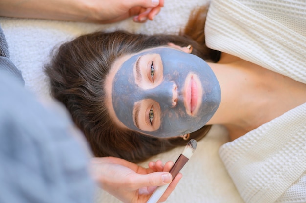 Top view of woman getting a face mask