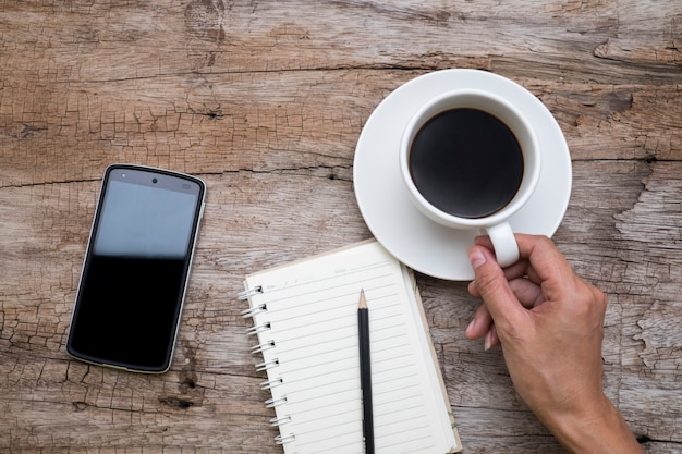 Top view of woman hand holding a cup of coffee,