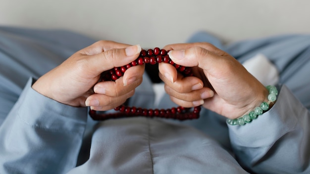 Free photo top view of woman holding beads and meditating