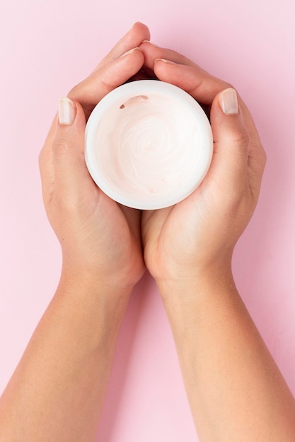 Top view woman holding a face cream box