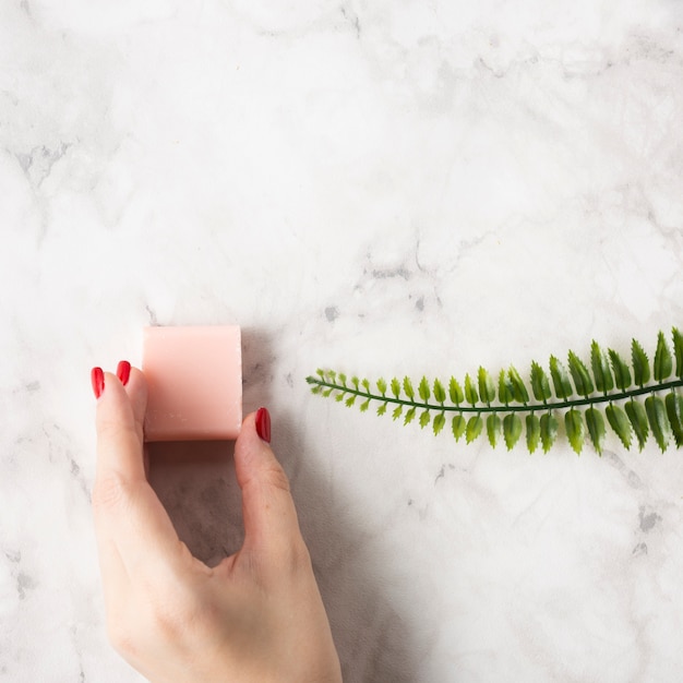 Top view woman holding a pink soap