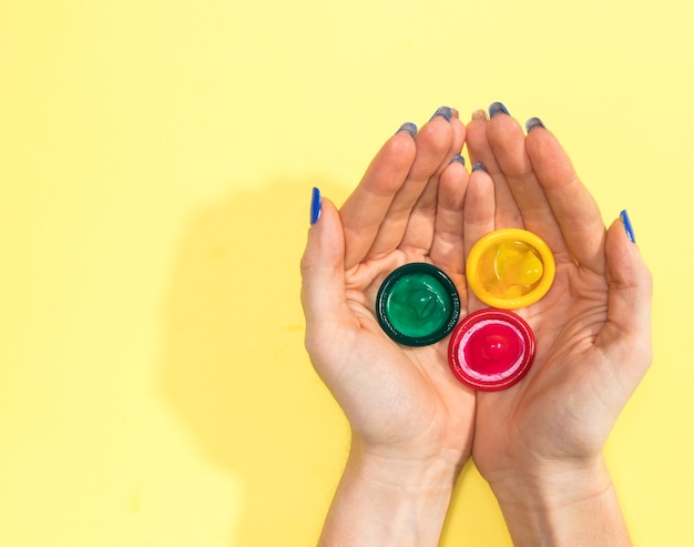 Free Photo top view woman holding three condoms