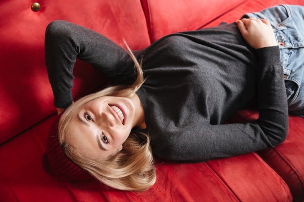 Top view of woman lying on armchair