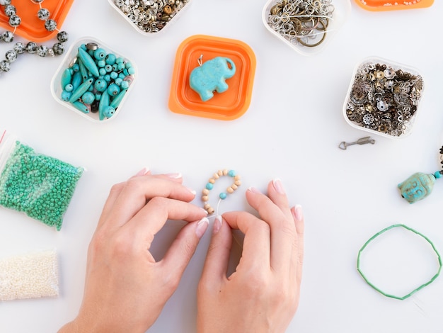 Free photo top view of woman making colored accessories