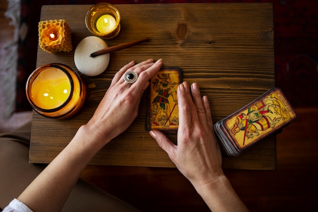 Free photo top view woman reading tarot