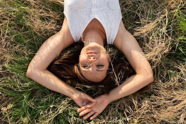 Top view of woman relaxing in nature on grass