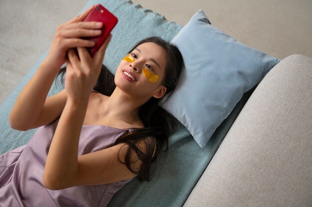 Top view woman using eye patches