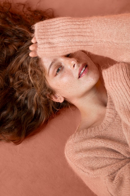 Free Photo top view woman wearing a pink sweater