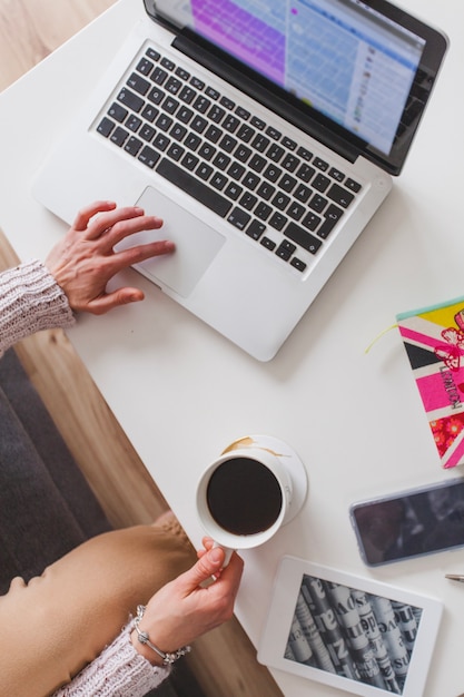 Top view of woman with laptop and coffee