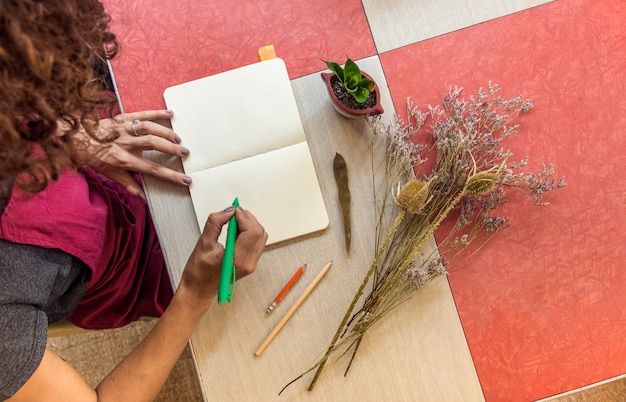 Top view woman writing in notebook