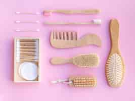 Free photo top view wooden items on pink background