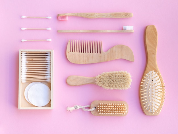 Free Photo top view wooden items on pink background