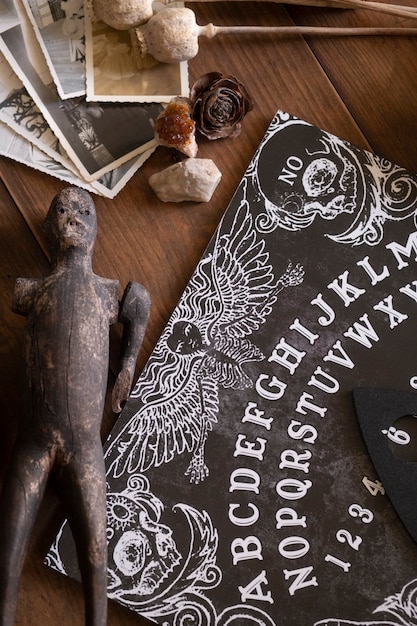 Free photo top view wooden ouija board and old doll