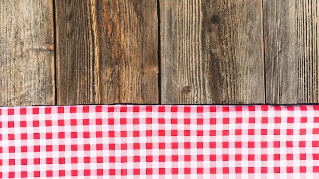 Free Photo top view of wooden plank and checkered tablecloth