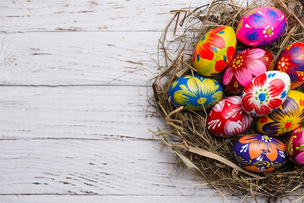 Free photo top view of wooden surface with painted easter eggs