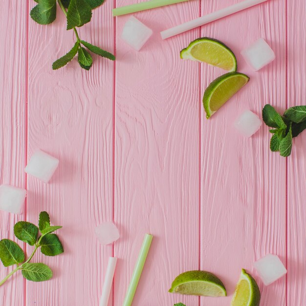 Top view of wooden surface with summer ingredients for drinks