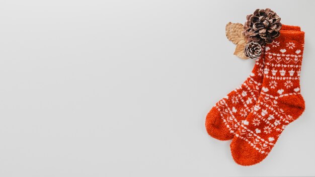 Top view wool socks and pine cones with copy-space