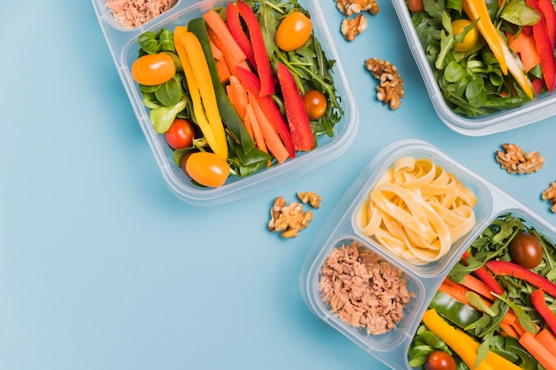 Top view work lunchboxes with walnuts