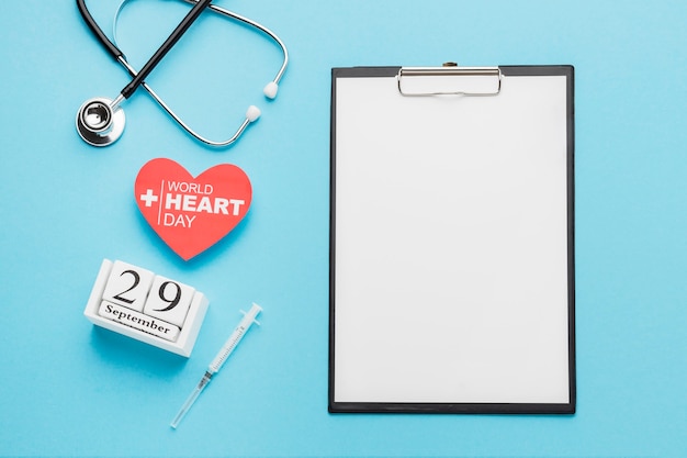 Top view world heart day concept with clipboard