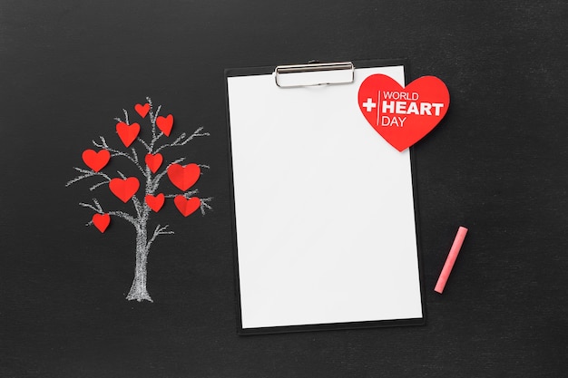 Free photo top view world heart day concept with notepad