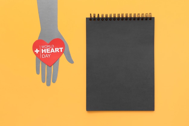 Free Photo top view world heart day with notepad