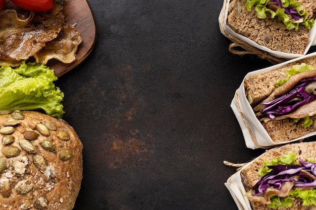 Top view of wrapped salad sandwiches with bread and copy space