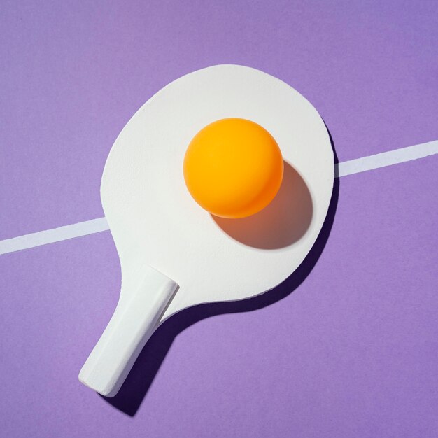 Top view yellow ball on ping pong paddle