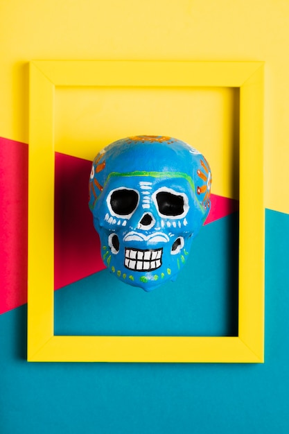 Free Photo top view yellow frame with blue skull