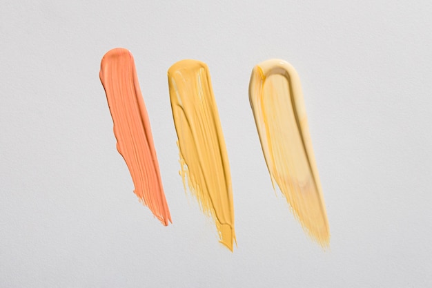 Free Photo top view of yellow paint brush strokes