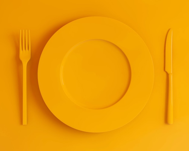 Top view yellow plate fork and knife on a yellow background