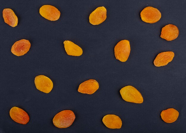 Top view of yellow raisins isolated on black background