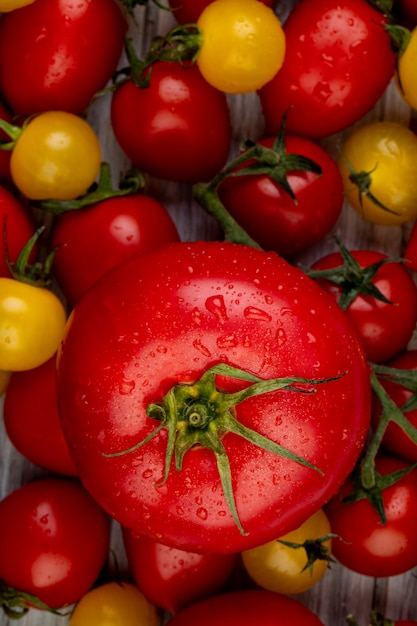 Top view of yellow and red tomatoes on wooden table