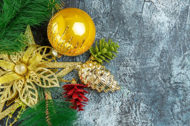 Top view yellow xmas tree ball xmas ornaments on grey surface