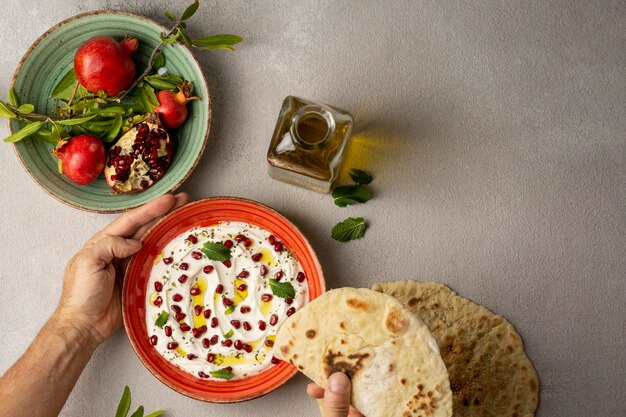 Top view of yogurt with pomegranate and oil