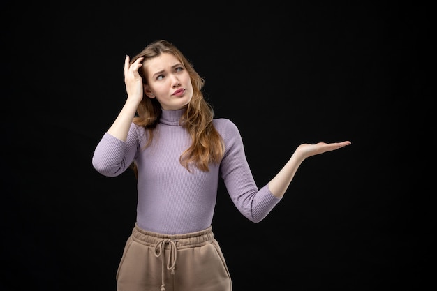 Top view of young girl thinking about something on dark