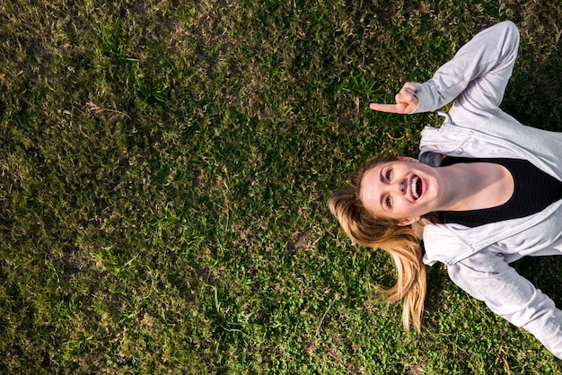 Free photo top view of a young woman on the ground