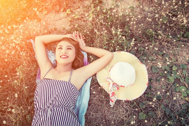 Free Photo top view of young woman lying close to her hat