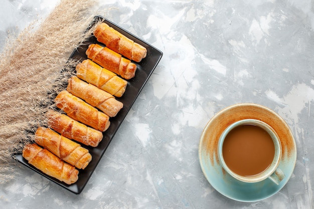 Top view yummy bangles with milk coffee on the light background pastry cooking cake sweet sugar