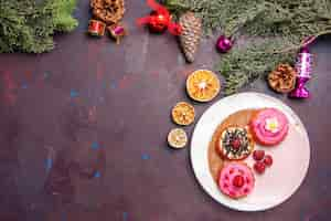 Free photo top view of yummy cakes with fruits and cream on black