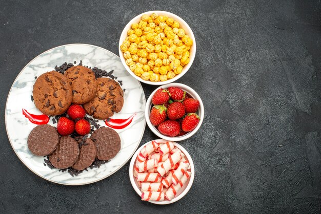 Top view yummy choco biscuits with candies on dark background sweet cookie cake sugar