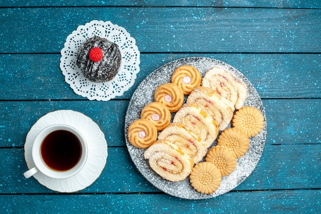 Top view yummy chocolate ball with cup of tea and cookies on blue rustic desk tea sweet cake cookie biscuit