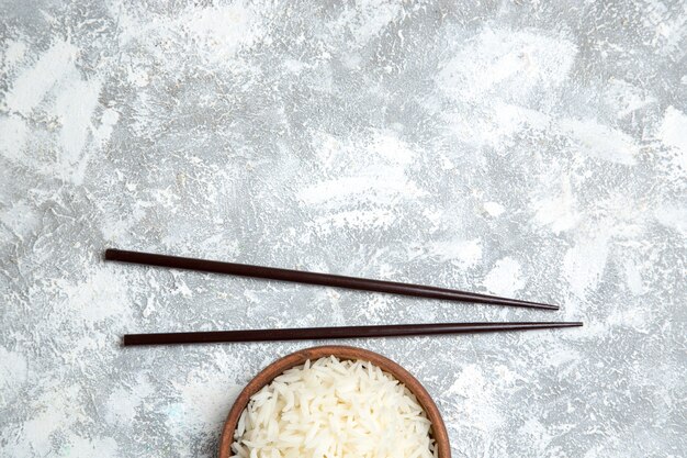 Top view yummy cooked rice inside brown plate on a light-white