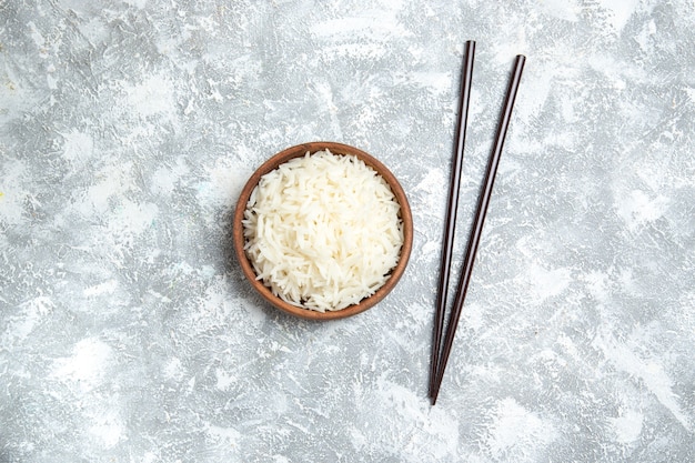 Free Photo top view yummy cooked rice inside brown plate on white